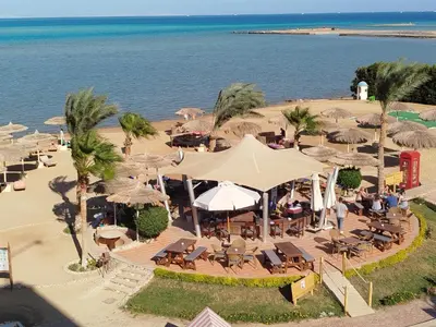 an overhead view of a beach with tables and umbrellas at Royal Beach G 05 in Hurghada