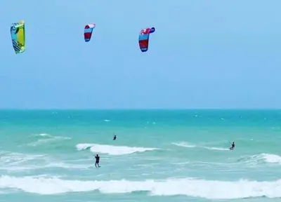 a group of people flying kites in the ocean at Royal Beach G 05 in Hurghada