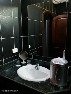 a bathroom with a sink and a mirror at Saluga Nubian Guest House in Aswan