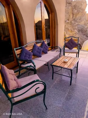 a living room with couches and a coffee table at Saluga Nubian Guest House in Aswan