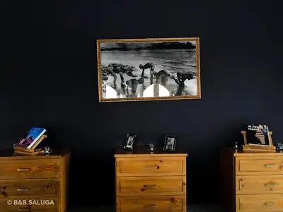 a bedroom with two dressers and a picture on the wall at Saluga Nubian Guest House in Aswan