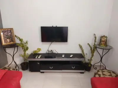 a living room with a flat screen tv on a wall at Hurghada City Apartment1 in Hurghada