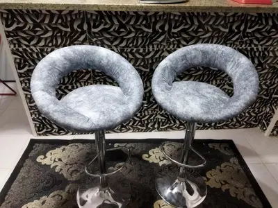 a pair of stools sitting in front of a fireplace at Hurghada City Apartment1 in Hurghada
