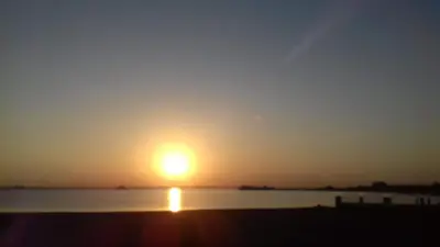 a sun setting over a body of water at Ahmed House 1 in Safaga