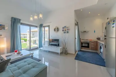 a living room with a couch and a refrigerator at Gcribs apartment pool view in El Gouna