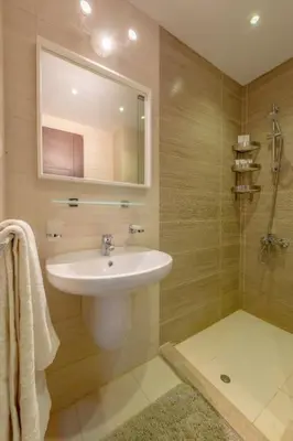 a bathroom with a sink and a shower with a mirror at Gcribs apartment pool view in El Gouna