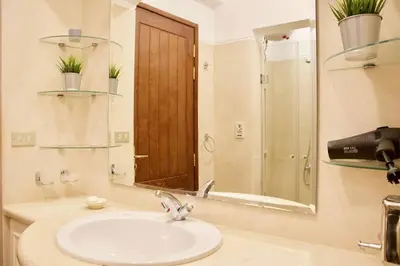 a bathroom with a sink and a mirror at Artsy 1 BR Apt/ Free Pool & Lagoon Access @ElGouna in Hurghada