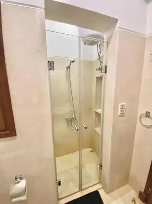 a shower with a glass door in a bathroom at Artsy 1 BR Apt/ Free Pool & Lagoon Access @ElGouna in Hurghada
