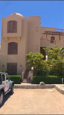 a white truck parked in front of a building at Artsy 1 BR Apt/ Free Pool & Lagoon Access @ElGouna in Hurghada