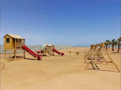 a playground on a beach with a play structure at Glamorous 2BR/ Free Beach & Pool Access @ Mangroovy, El Gouna in Hurghada