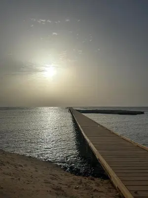 a wooden pier stretches out into the water on the beach at Exceptional Apartment in Soma Bay 4pax in Hurghada