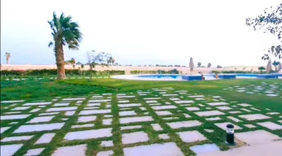 a view of a park with a pool and palm trees at Exceptional Apartment in Soma Bay 4pax in Hurghada