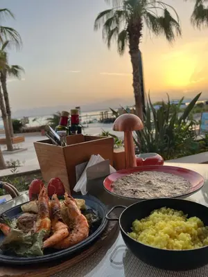 a table with two plates of food on a table at Exceptional Apartment in Soma Bay 4pax in Hurghada