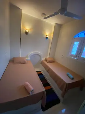 a room with two beds and a window at SmSm Kato in Aswan