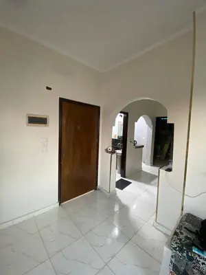 a large room with a door and a tile floor at SmSm Kato in Aswan