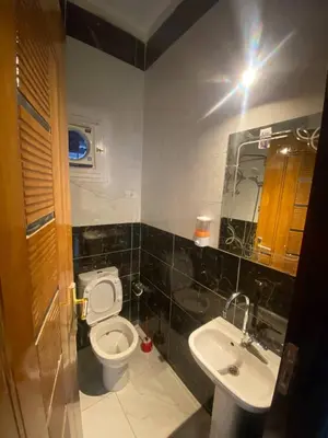 a bathroom with a toilet and a sink at SmSm Kato in Aswan