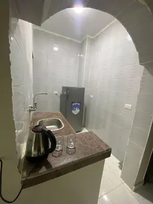 a kitchen with a sink and a tea kettle on a counter at SmSm Kato in Aswan
