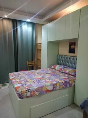 a bedroom with a bed with a quilt on it at Harmony Sunny Chalet With Wi-Fi in Hurghada
