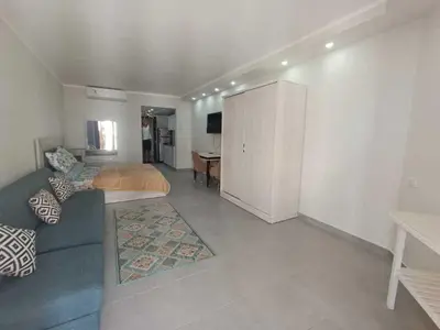 a living room with a couch and a bedroom at Perfect For couples Sunny & SeaView with Wi-Fi in Hurghada