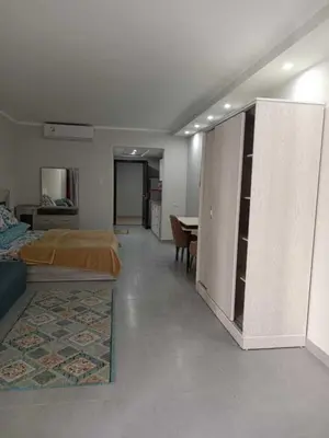 a bedroom with a bed and a table in it at Perfect For couples Sunny & SeaView with Wi-Fi in Hurghada