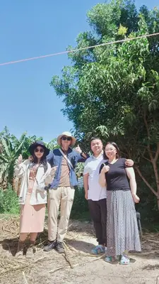 a group of people standing in front of a tree at Dream Garden Luxor in Luxor