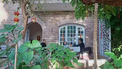 a group of people sitting at a table in a building at Dream Garden Luxor in Luxor