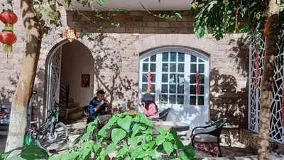 two people sitting at a table in a building at Dream Garden Luxor in Luxor