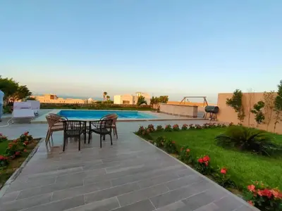 a patio with a table and chairs next to a swimming pool at The view compound in Hurghada