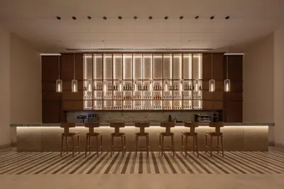 a bar with bar stools in a room at JAZ Elite Asteria in Hurghada