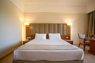 a hotel room with a large bed with two pillows at Serenity Alma Heights - Ex Serenity Fun City in Hurghada