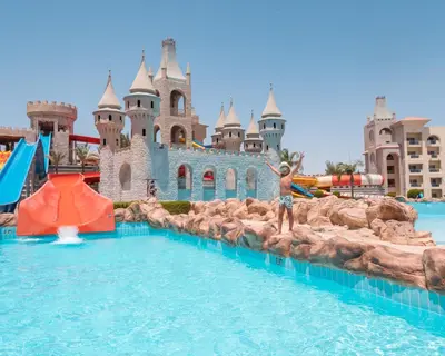 a boy in front of a castle at the water park at Serenity Alma Heights - Ex Serenity Fun City in Hurghada