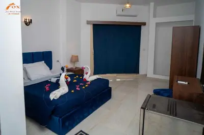 a living room with a blue couch with swans on it at Fox Resort El Gouna in Hurghada