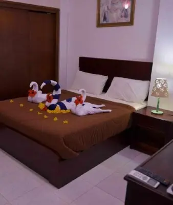 two stuffed animals are sitting on a bed at Fox Resort El Gouna in Hurghada