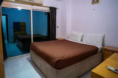 a bedroom with a bed in a room with a window at Fox Resort El Gouna in Hurghada