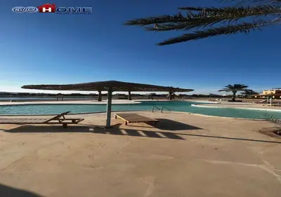 a picnic table and umbrella next to a swimming pool at Apartment -Y97-0-8- 1 BR Sabina in Hurghada