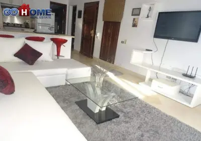a living room with a white couch and a tv at Apartment -Y97-0-8- 1 BR Sabina in Hurghada