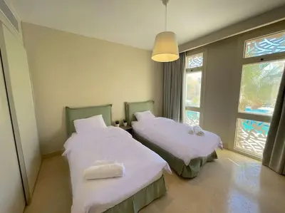 two beds in a room with a window at Stunning 2 BR/ Free Beach & Pool Access @ Mangroovy, El Gouna in Hurghada