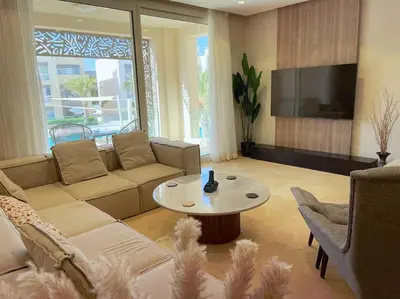 a living room with a couch and a table at Stunning 2 BR/ Free Beach & Pool Access @ Mangroovy, El Gouna in Hurghada