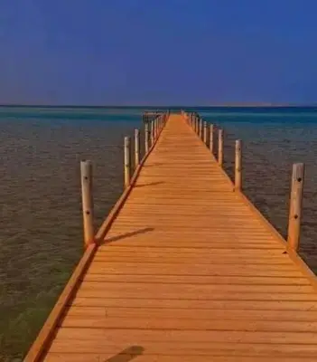 a wooden pier stretches out into the water at Fox House Beach Resort & Spa El Gouna in Hurghada