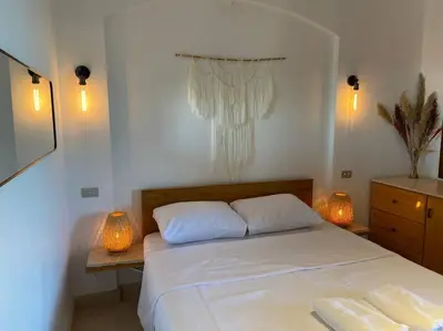 a bedroom with a bed with two towels on it at Magical 2BR Ground/Free Pool & Lagoon Access @ElGouna in Hurghada