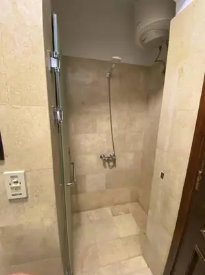 a shower with a glass door in a bathroom at Magical 2BR Ground/Free Pool & Lagoon Access @ElGouna in Hurghada