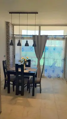 a dining room with a table and chairs at Evi's Infinity Sea View Apartment in Hurghada
