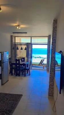 a kitchen and dining room with a view of the ocean at Evi's Infinity Sea View Apartment in Hurghada