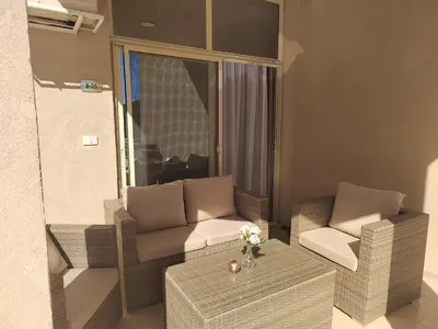 a living room with a couch and chairs and a table at Velký apartmán Princess Resort Hurghada in Hurghada