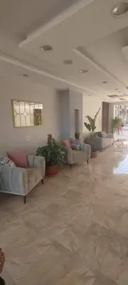 a large living room with couches and plants in it at Velký apartmán Princess Resort Hurghada in Hurghada