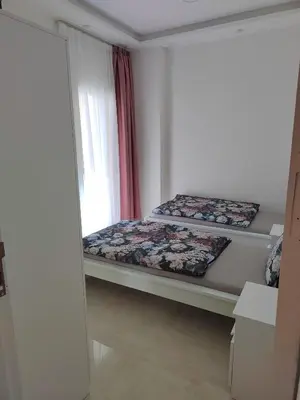 two beds in a room with a window at Velký apartmán Princess Resort Hurghada in Hurghada