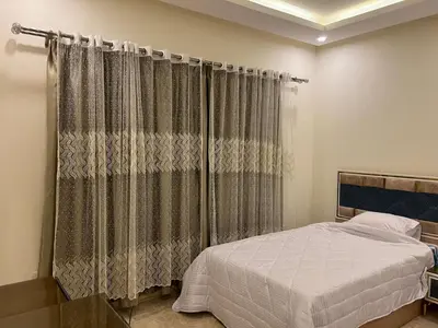 a bedroom with a bed and a curtain at Mirage bay in Hurghada