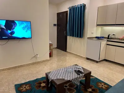 a living room with a flat screen tv on a wall at Mirage bay in Hurghada