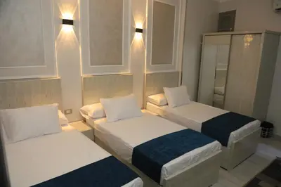 a small room with two beds and a mirror at Crystala guest house in Aswan