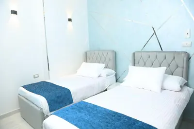 two beds sitting next to each other in a room at Crystala guest house in Aswan